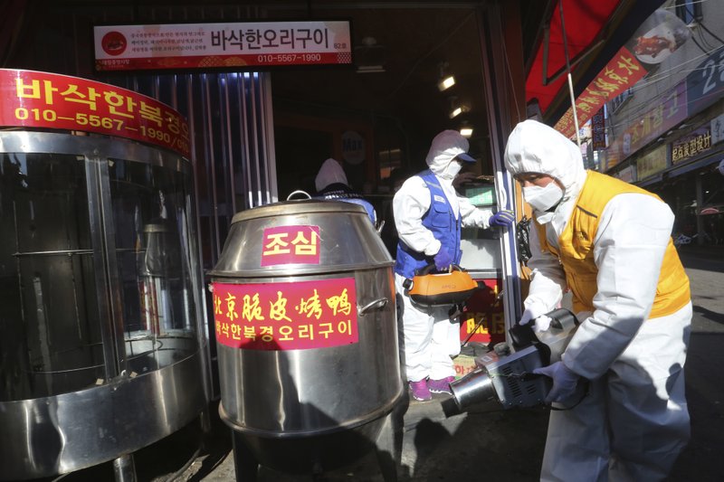 Workers wearing protective gear spray disinfectant at a Chinese duck restaurant as a precaution against a new coronavirus at Daelim market in Seoul, South Korea, Wednesday. Deaths from a new virus rose to 490 in mainland China on Wednesday while new cases on a Japanese cruise ship, in Hong Kong and in other places showed the increasing spread of the outbreak and renewed attention toward containing it. - AP Photo/Ahn Young-joon story.lead_photo.caption
