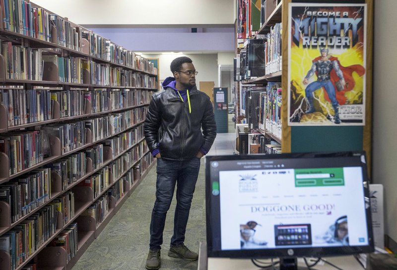 John Summerville of Bentonville peruses the collection Friday, Jan. 24, 2020, at the Rogers Public Library. 
(NWA Democrat-Gazette/Ben Goff)