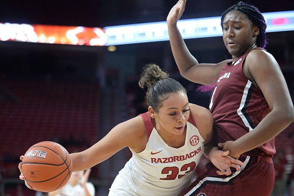 Arkansas guard Chelsea Dungee (left) drives to the basket Thursday, Feb. 6, 2020, as she is guarded by South Carolina forward Aliyah Boston during the first half of play in Bud Walton Arena.