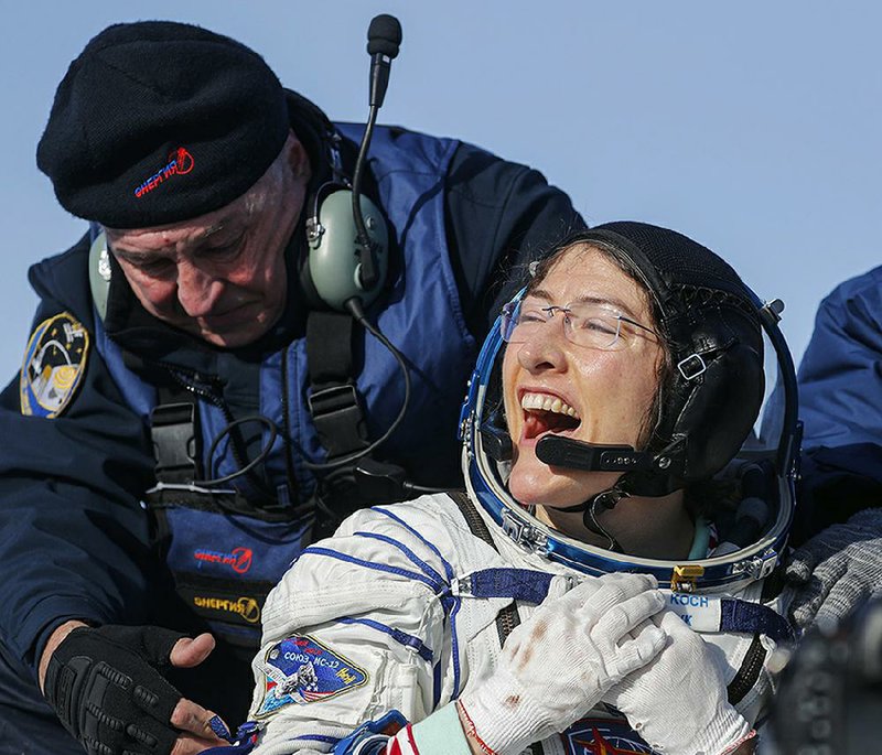 U.S. astronaut Christina Koch celebrates her return to Earth on a snowy desert plain in Kazakhstan on Thursday after setting the record for the longest single spaceflight for a woman at 328 days. More photos at arkansasonline.com/27nasa/. Video at arkansasonline.com/27mission/.  