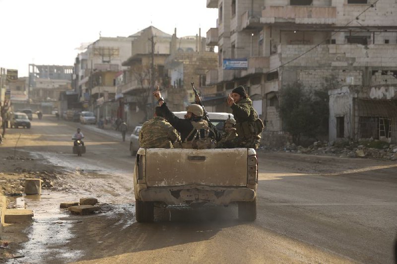 Syrian rebels drive toward government positions Thursday near the village of Nerab in Idlib province. More photos are available at arkansasonline.com/27syria/  