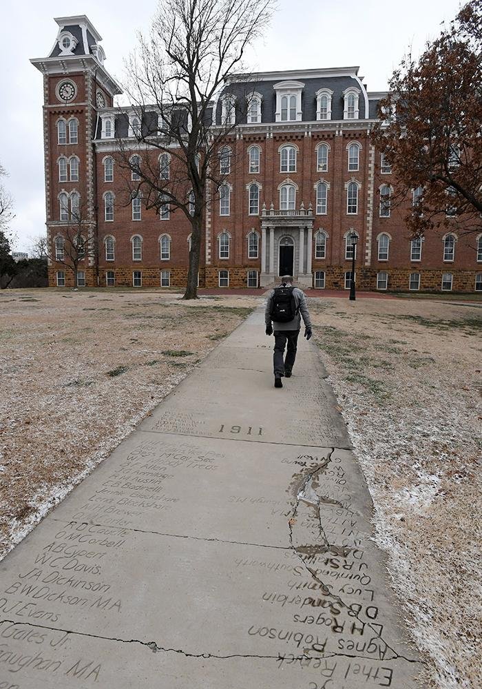 Senior sidewalks are cracking in front of Old Main on the University of Arkansas campus in Fayetteville. The damaged areas are from the late 1800s and early 1900s. 