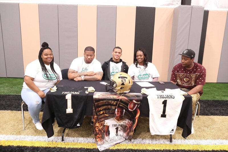 Santiair Thomas, center, signed to play football at Missouri Southern State at Hot Springs High School Wednesday. Joining him are, from left, stepmother Dominique Roberts, father Robert White, mother Santana Ware and stepfather Tony Ware. - Photo by Richard Rasmussen of The Sentinel-Record
