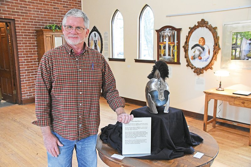 Conway artist/photographer Don Byram uses this Spartan helmet in each of the photos he displays in the Everyday a Warrior exhibit currently on view at Saint Peter’s Episcopal Church Parish Hall in Conway. He said the helmet represents the “inner warrior” of the women he photographed, who share their stories of abuse, mental illness, addiction and abandonment in written testimonies displayed alongside their photographs.