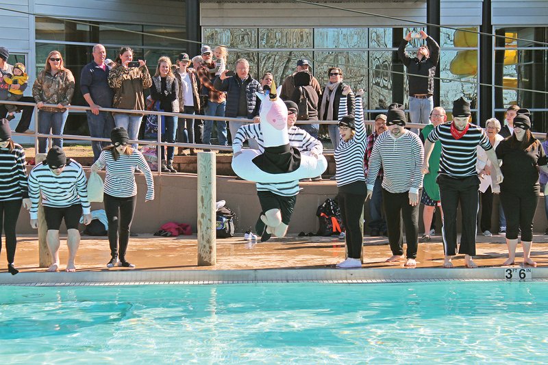 Brandt McDonald goes in with a giant unicorn floaty at the Polar Plunge on Feb. 1 at the Batesville Aquatics Center. He was part of Team First Community Bank, which also won the costume contest (bank robbers) in the team division. With 14 plungers, the team tied with Citizens Bank in the Battle of the Banks.  Together, participants raised more than $11,000 for Special Olympics Arkansas.