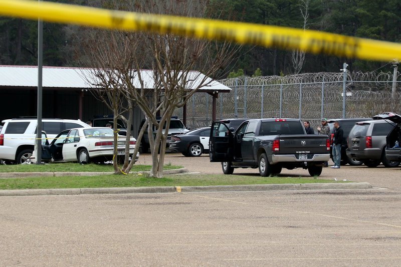 Officers with the Union County Sheriff's Office wait in the parking lot for Arkansas State Police to arrive following a shooting Feb. 7. The suspect, who was shot in the arm by a Union County Sheriff's Office deputy, was transported to the Medical Center of South Arkansas where he was treated and released into USCO's custody. - Photo by Siandhara Bonnet/El Dorado News-Times