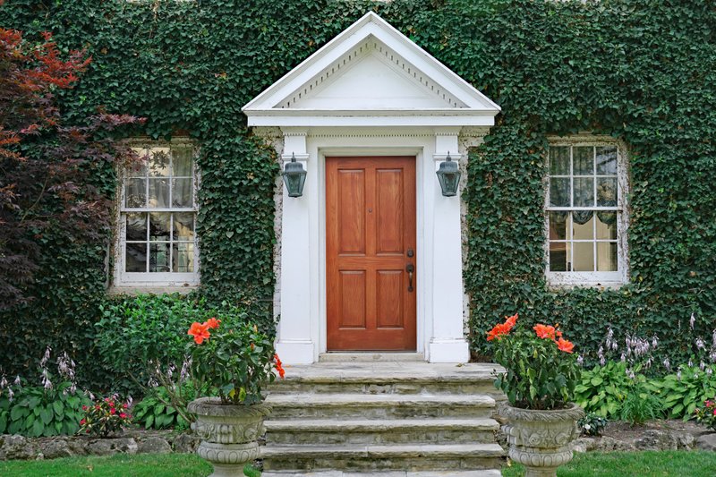 Though creeping ivy drives some home gardeners up the wall and can damage wood and stucco, when properly maintained, it can also add charm, grandeur and a sense of timelessness to a home and landscape. (Courtesy of Spiroview for Dreamstime)