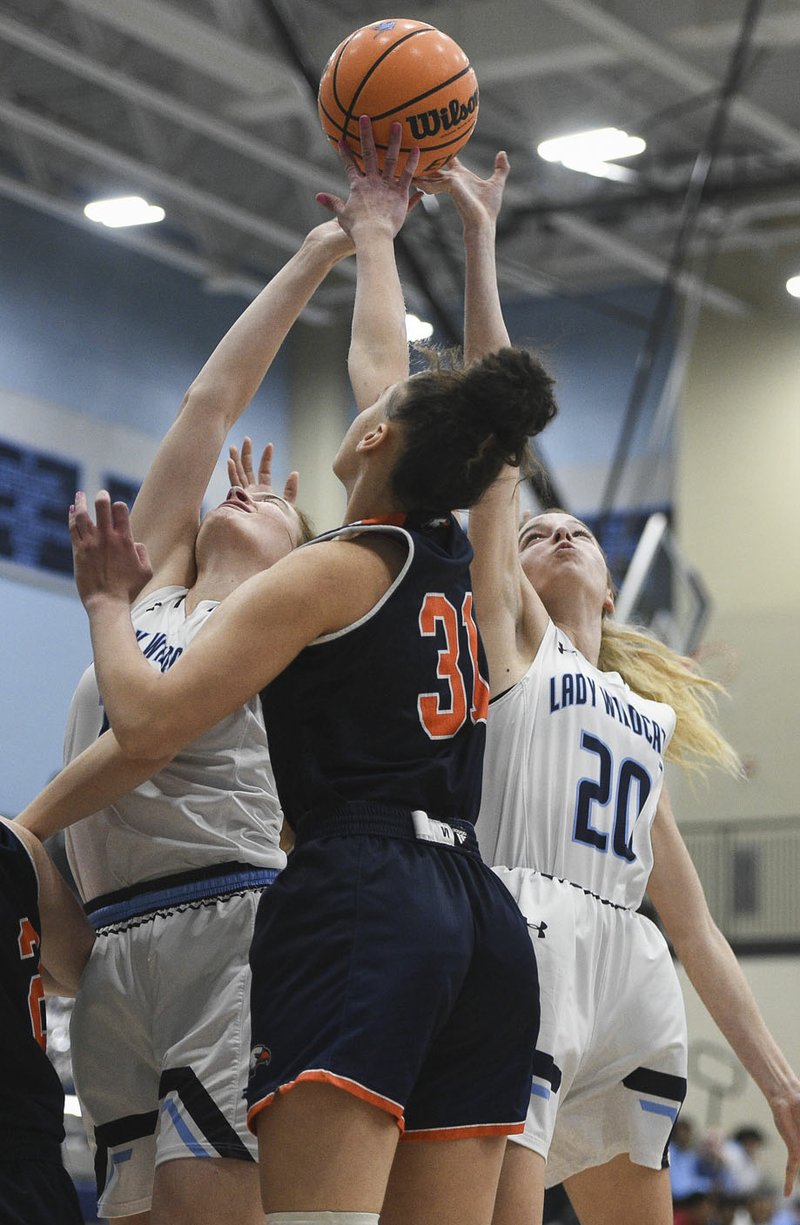 Har-Ber Claire Doty (31) and Har-Ber forward Mary Blake Martfeld (20) reach for a rebound, Friday, February 7, 2020 during a basketball game at Wildcat Arena at Har-Ber High School in Springdale. Check out nwaonline.com/prepbball/ for today&#x2019;s photo gallery. (NWA Democrat-Gazette/Charlie Kaijo)