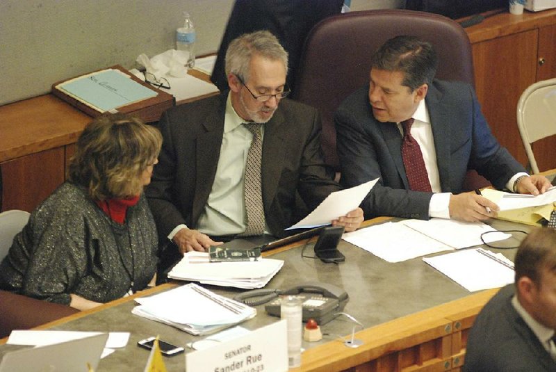 New Mexico Reps. Joy Garratt (from left) and Daymon Ely and Sen. Joseph Cervantes, sponsors of the red-flag legislation, confer Friday during a floor debate in the state Senate.
(AP/Morgan Lee)