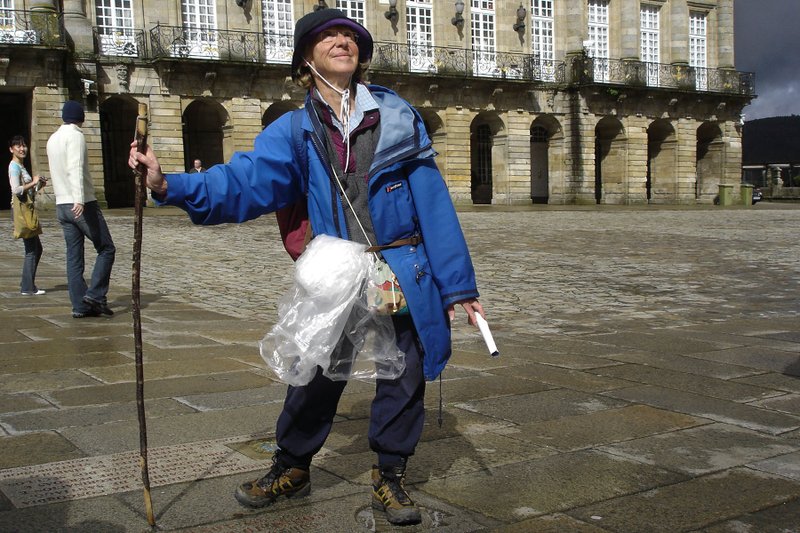 A jubilant pilgrim on Spains Camino de Santiago marks the end of her journey in front of the cathedral in Santiago de Compostela.
(Rick Steves' Europe/Rick Steves)