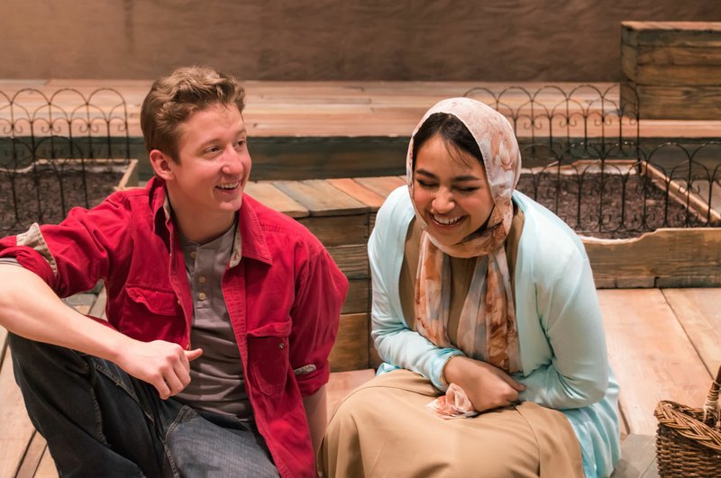 "'In The Book Of' tells a story that grapples with the most contentious argument in America today: who should be allowed to be called 'American',"notes actor Leah Smith. "What I love about this show, and all good theatre, is that it brings the audience closer to understanding both sides of the argument and empathize with why people feel the way they do. If the people as a whole can understand and relate to where the opposite sides are coming from, that is the first step to resolving our differences. It's a story that America and the world should be hearing." Pictured are Riley Newsome as Bo Jr. and Melissa Monzabi as Anisa. (Courtesy Photo/University Theatre)
