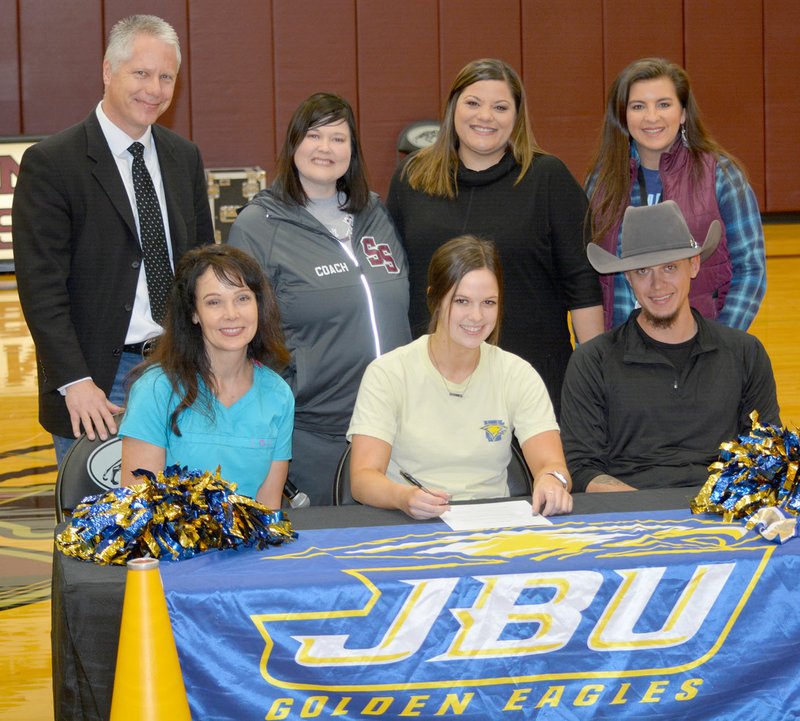 Graham Thomas/Siloam Sunday Siloam Springs senior Rachel Robbins signed a letter of intent Wednesday to join the cheerleading team at John Brown University. Pictured are: Front from left, mother Melinda Ericson, Rachel Robbins, brother Dalton Robbins; back, father Ed Ericson, SSHS cheer coach Cara Beth Whorton, John Brown cheer coach Elicia Williamson and SSHS cheer coach Jackie Clement.