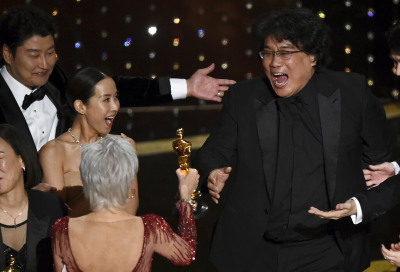 Bong Joon Ho (right) reacts as he is presented with the award for best picture for "Parasite" from presenter Jane Fonda at the Oscars on Sunday, Feb. 9, 2020, at the Dolby Theatre in Los Angeles. Looking on from left are Kang-Ho Song and Kwak Sin Ae.
