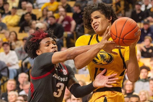 Missouri's Dru Smith, right, is fouled by Arkansas' Desi Sills, left, during the first half of an NCAA college basketball game Saturday, Feb. 8, 2020, in Columbia, Mo. (AP Photo/L.G. Patterson)