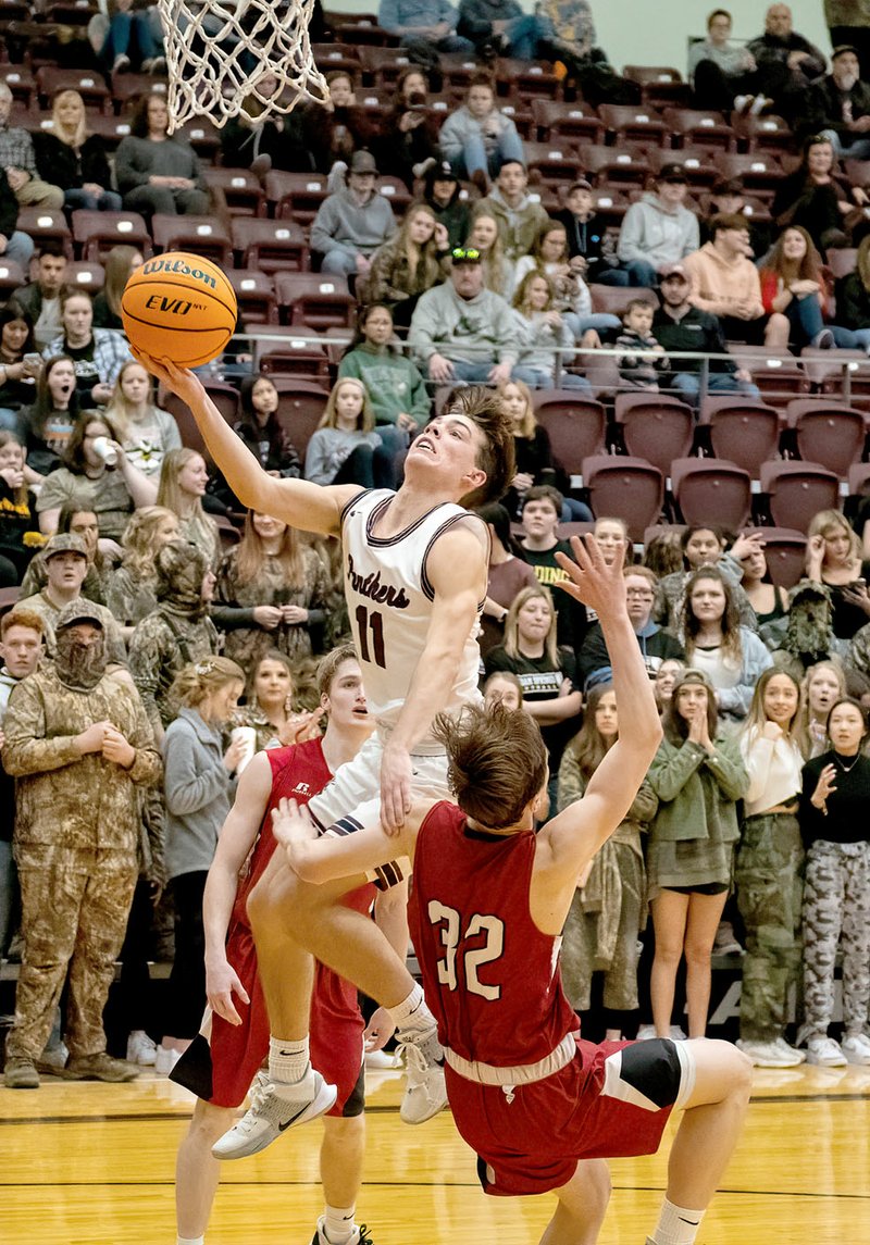 Bud Sullins/Special to Siloam Sunday Siloam Springs senior Evan Sauer drives to the basket as Beebe's Logan Worthington tries to draw a charge during Friday's homecoming game at Panther Activity Center. Beebe defeated Siloam Springs 53-41.