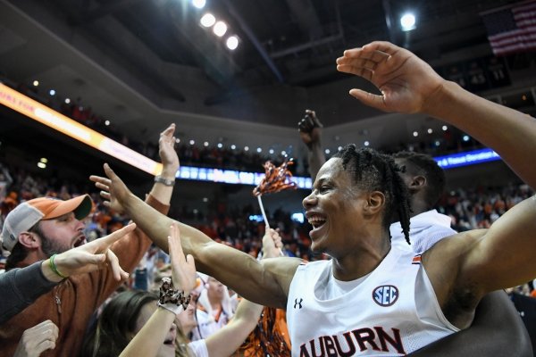 Auburn forward Isaac Okoro (23) celebrates with fans after their overtime win over LSU in an NCAA college basketball game Saturday, Feb. 8, 2020, in Auburn, Ala. (AP Photo/Julie Bennett)
