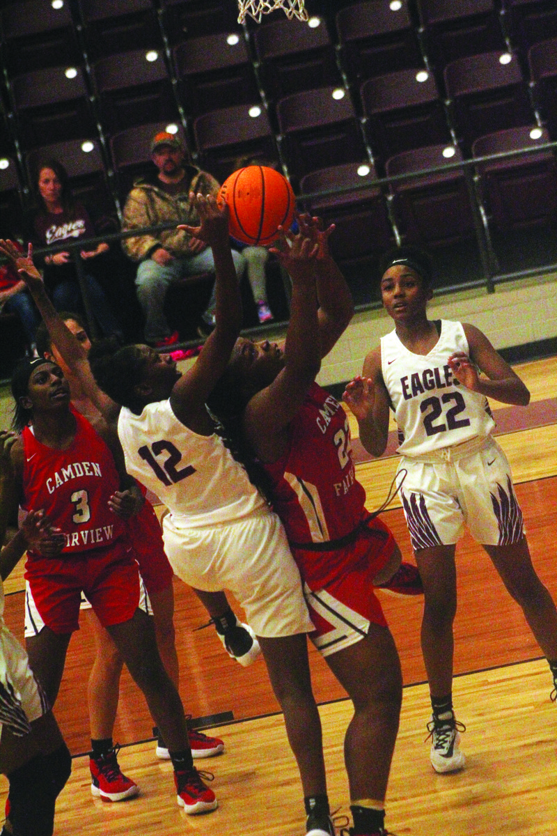 No call

Camden Fairview’s Jhiya Jefferson (22) attempts to make a rebound as a Crossett player leans over her back. The officials let the physical play continue.