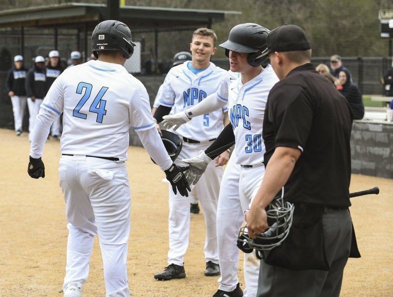 National Park freshman Jesus Minjarez (24) is congratulated by teammates after hitting a three-run home run in the first game of Monday's doubleheader. - Photo by Grace Brown of The Sentinel-Record