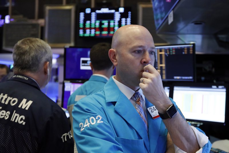 FILE - In this Feb. 6, 2020, file photo specialist Jay Woods works at his post on the floor of the New York Stock Exchange. Stocks are wobbling between small gains and losses in early trading on Monday, Feb. 10, on Wall Street following a big gain from last week. (AP Photo/Richard Drew, File)