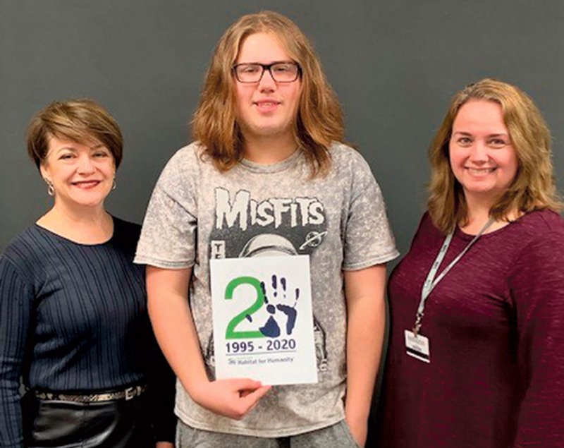 Cindy Wagstaff, left, Garland County Habitat for Humanity executive director, and Glenda Davis, National Park College Technology Center Graphic Design instructor, with Gabriel Garza, holding his winning logo design. - Submitted photo