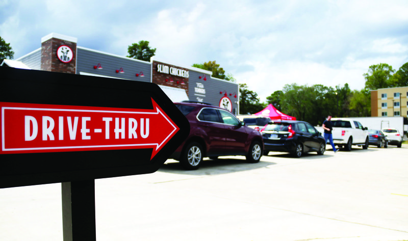 Booming Open: Cars line up for the drive-thru at Slim Chickens on North West Avenue Sept. 19, 2019. The fast-food chicken place opened last year to large crowds, said John Luckett, chief operating partner of Dixie Chicken, LLC, the franchise owner of Slim Chickens in El Dorado.