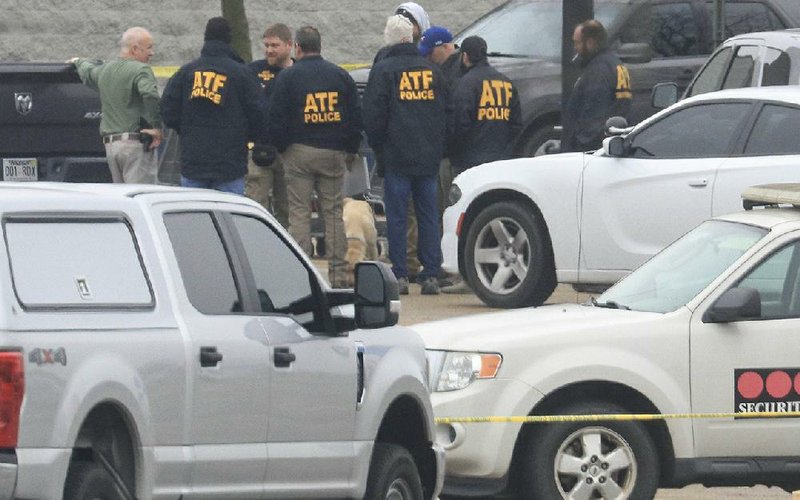 Officers from multiple agencies, including the federal Bureau of Alcohol, Tobacco, Firearms and Ex- plosives, investigate Monday’s shooting at a Walmart in Forrest City. More photos at arkansasonline. com/211walmart/. 
