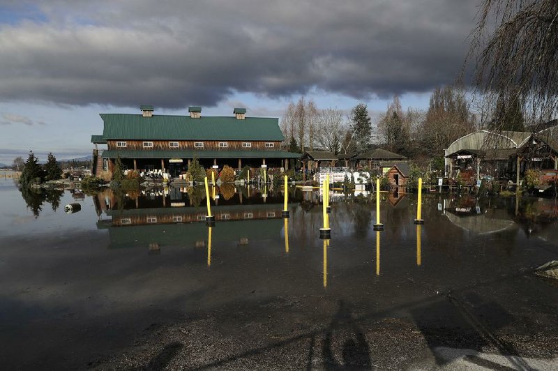 Floodwaters cover the grounds Monday around the Root Cellar Boutique store at Skagit Valley Gardens near Mount Vernon, Wash.  