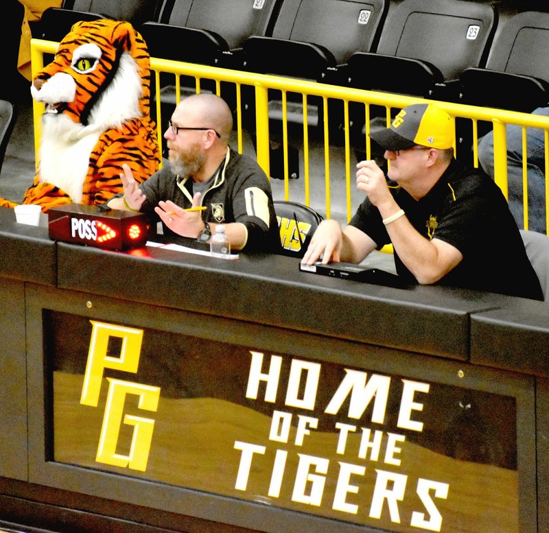 MARK HUMPHREY ENTERPRISE-LEADER Among Maverick the Tiger's antics are occasionally helping out coaches Craig Laird and John Elder at the scorer's table. Maverick is the Prairie Grove roving mascot, who regularly employs appropriate means to entertaining the crowd and drumming up school spirit.