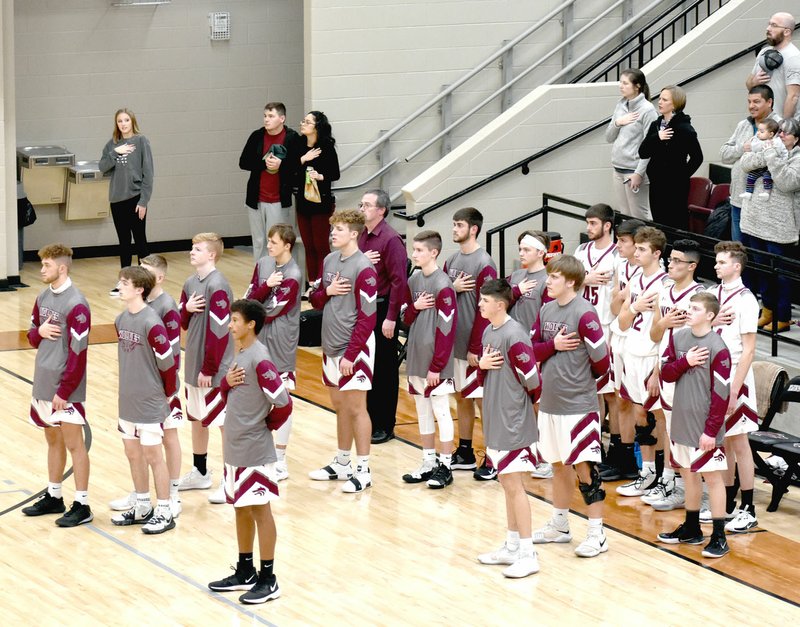 MARK HUMPHREY ENTERPRISE-LEADER Lincoln's boys varsity basketball team, coaches and fans salute the United States' flag while the National Anthem is performed by the school's pep band prior to tip-off. Lincoln held off Cedarville, 71-68, during a 3A-1 West Conference boys basketball game at Wolfpack Arena on Tuesday, Jan. 28. story.lead_photo.caption