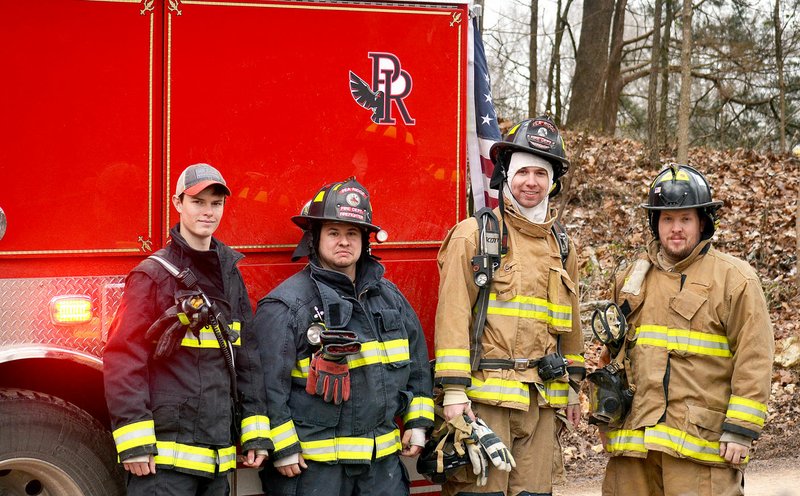 TIMES photograph by Annette Beard Pea Ridge volunteer firefighters Riley Heasley, Chris Perez, Ben Osowiecki and Shane Henson were several of the firefighters to respond to a structure fire on DeGraff Road involving a chimney fire recently. The fire trucks now have a Blackhawk decal on them thanks to permission from the school, according to Fire Chief Jack Wassman.