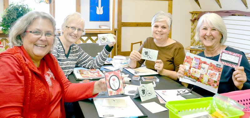 Keith Bryant/The Weekly Vista Deb Dakken (left) shows off a card she's made, alongside Carrie Hamilton, Charla Everhart and Jane Para during a cardmaking class at the Wishing Spring Gallery last Friday. Para hosts a cardmaking class on the second Friday of each month, from 3 to 5 p.m. Materials are included at $5 per card and attendees may make up to three cards.