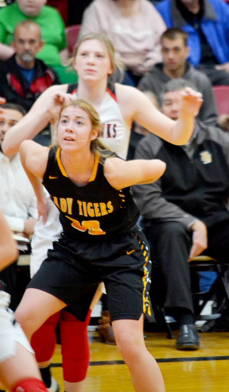 Staff photograph by Annette Beard Prairie Grove sophomore Abby Preston boxes out junior Lady Blackhawk Josey Goldberg (No. 2) during the Colors Day contest Friday, Feb. 7, in Pea Ridge. Pea Ridge defeated the Lady Tigers, 41-37.