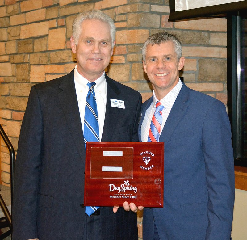 Janelle Jessen/Herald-Leader Chamber president Arthur Hulbert (right) presents chamber board chair and DaySpring CEO James Barnett with a Diamond Member award recognizing the business for being a chamber member for 25 years.
