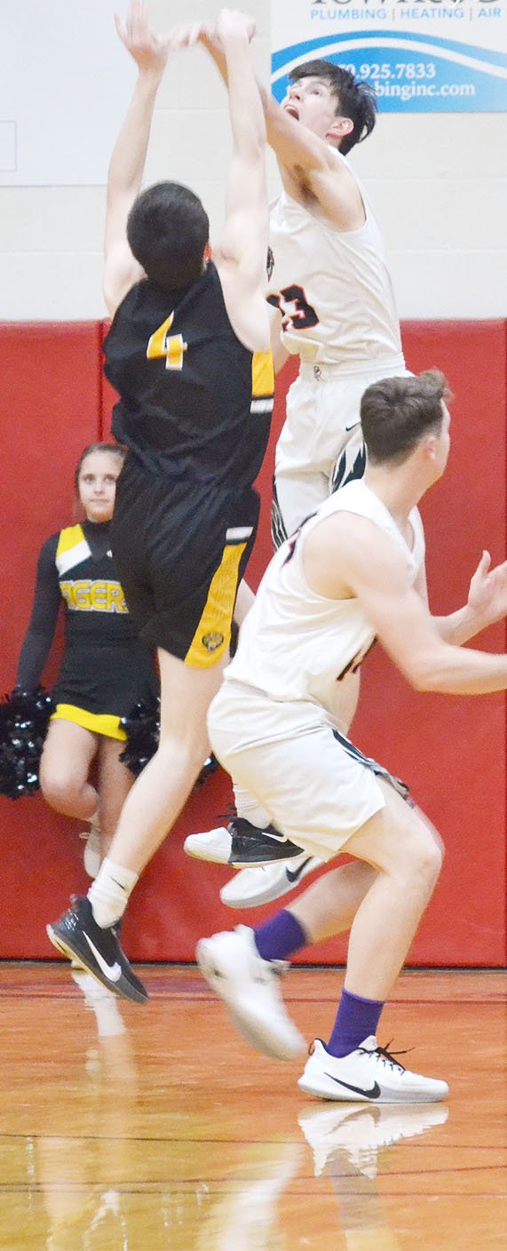 TIMES photograph by Annette Beard Senior Blackhawk Wes Wales (No. 23) jumps to block a shot by a Prairie Grove player Friday, Feb. 7, 2020, during the Colors Day game. For his defensive efforts, Wales was named Nighthawk player of the game, according to coach Trent Loyd.