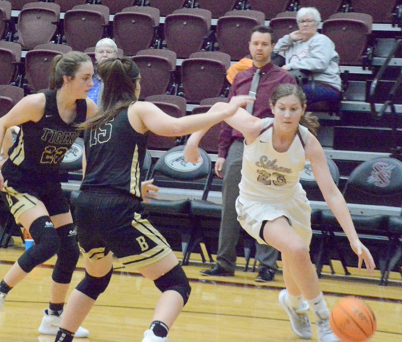 Graham Thomas/Herald-Leader Siloam Springs freshman Brooke Smith, right, drives the baseline against Bentonville on Monday in a ninth-grade girls basketball game inside Panther Activity Center.