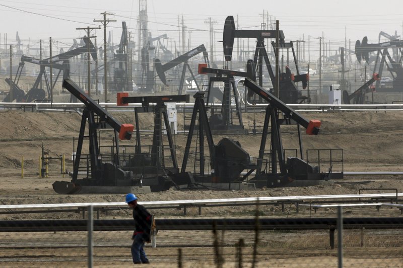 FILE - This Jan. 16, 2015, file photo shows pumpjacks operating at the Kern River Oil Field in Bakersfield, Calif., which is overseen by the U.S. Bureau of Land Management. Oil production from federally-managed lands and waters topped a record 1 billion barrels in 2019, according to the Department of Interior on Tuesday, Feb. 11, 2020. (AP Photo/Jae C. Hong, File)