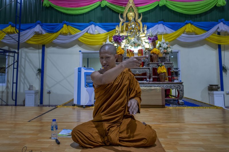 In this Monday, Feb. 10, 2020 photo, Buddhist monk Phra Manaswin gestures as he explains a shooting rampage he witnessed at Wat Pa Sattharuam Buddhist temple in Nakhon Ratchasima, Thailand. The secluded temple complex in the northeastern Thai province had opened its gates for Buddha Day, allowing in dozens of devotees, when a rogue soldier from the neighboring Army base roared through in a stolen Humvee, fatally shooting nine people, including a 13-year-old boy, and injuring more. (AP Photo/Gemunu Amarasinghe) story.lead_photo.caption