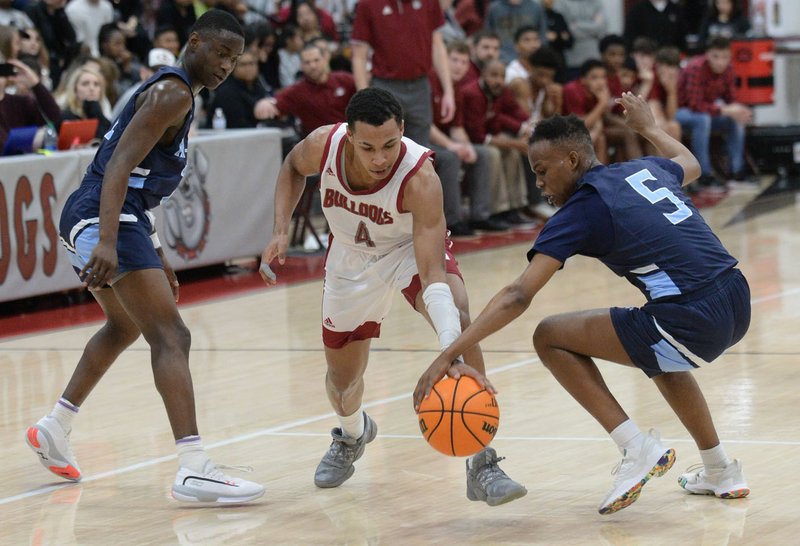 Springdale's Grant James (4) attempts to dribble Tuesday, Feb. 11, 2020, past Har-Ber's Tavari Eckwood (5) as Jajuan Boyd (left) defends during the first half of play in Bulldog Arena in Springdale. Visit nwaonline.com/prepbball/ for a gallery from the games. (NWA Democrat-Gazette/Andy Shupe)