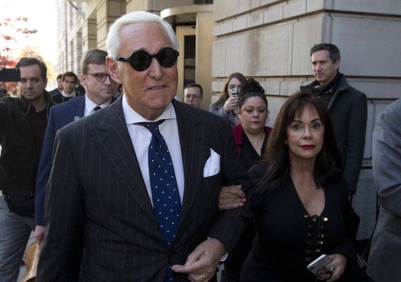 FILE - In this Nov. 15, 2019, file photo, Roger Stone, left, with his wife Nydia Stone, leaves federal court in Washington, Friday, Nov. 15, 2019.  (AP Photo/Jose Luis Magana, File)