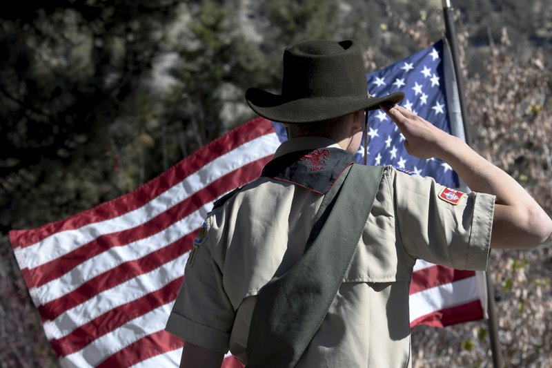 FILE - In this Sunday, Nov. 11, 2018 file photo, Boy Scouts lead the Pledge of Allegiance to begin a Veterans Day ceremony in Wrightwood, Calif. Facing a possible bankruptcy due to sex-abuse litigation, the Boy Scouts of America issued a new apology Tuesday, Feb. 11, 2020, to survivors of abuse and announced plans for expanded services to support them. (James Quigg/The Daily Press via AP)
