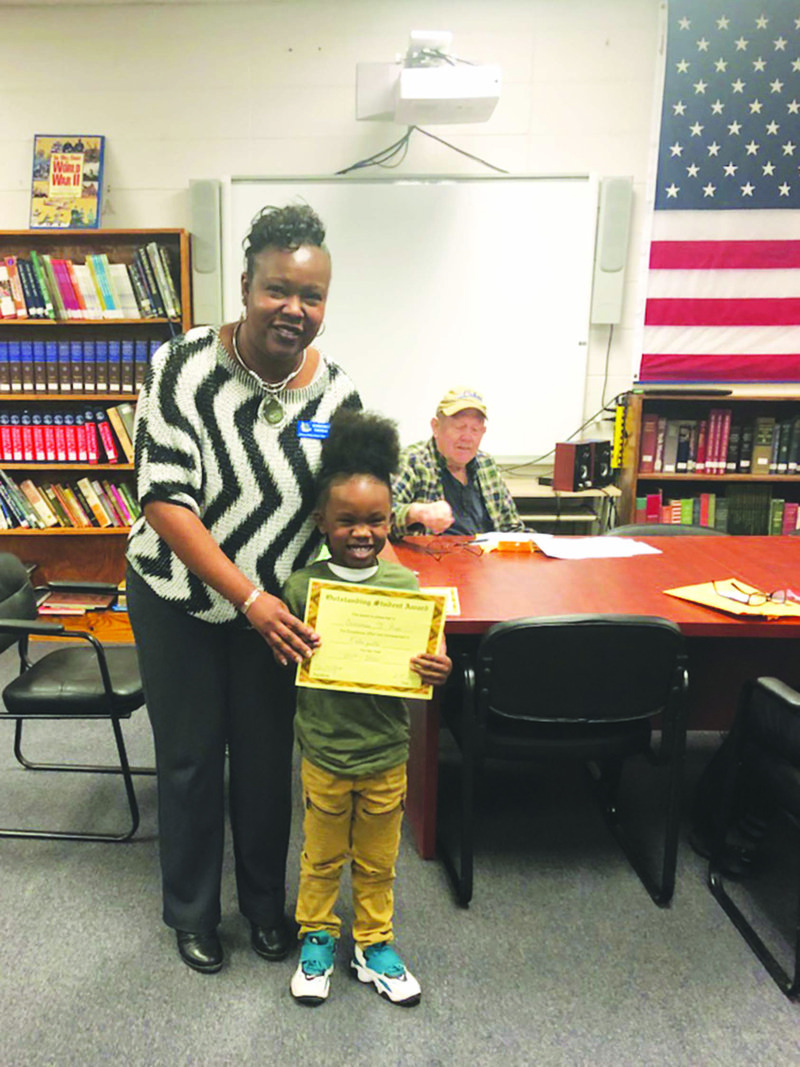 Outstanding: Strong-Huttig Superintendent Kimberly Thomas presents an Outstanding Student of the Month award to kindergartener Damarean Page during the school board meeting Feb. 10. story.lead_photo.caption