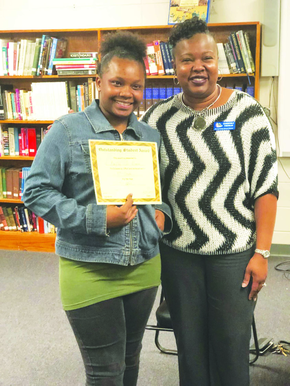 Top Student: Strong-Huttig Superintendent Kimberly Thomas presents an Outstanding Student of the Month award to sixth grader Kaylee Dixon during the school board meeting Feb. 10.