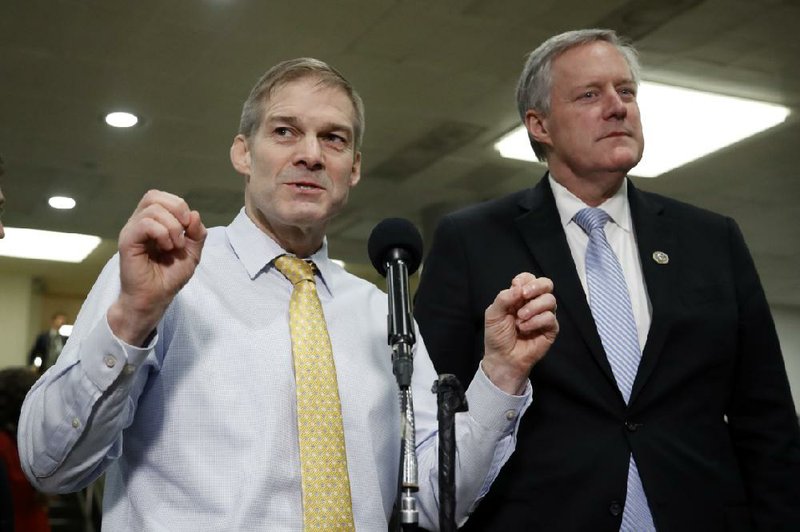 Rep. Jim Jordan, R-Ohio, left, speaks to reporters while standing next to Rep. Mark Meadows, R-N.C., on Capitol Hill in Washington, Thursday, Jan. 30, 2020, during the impeachment trial of President Donald Trump on charges of abuse of power and obstruction of Congress. (AP Photo/Julio Cortez)