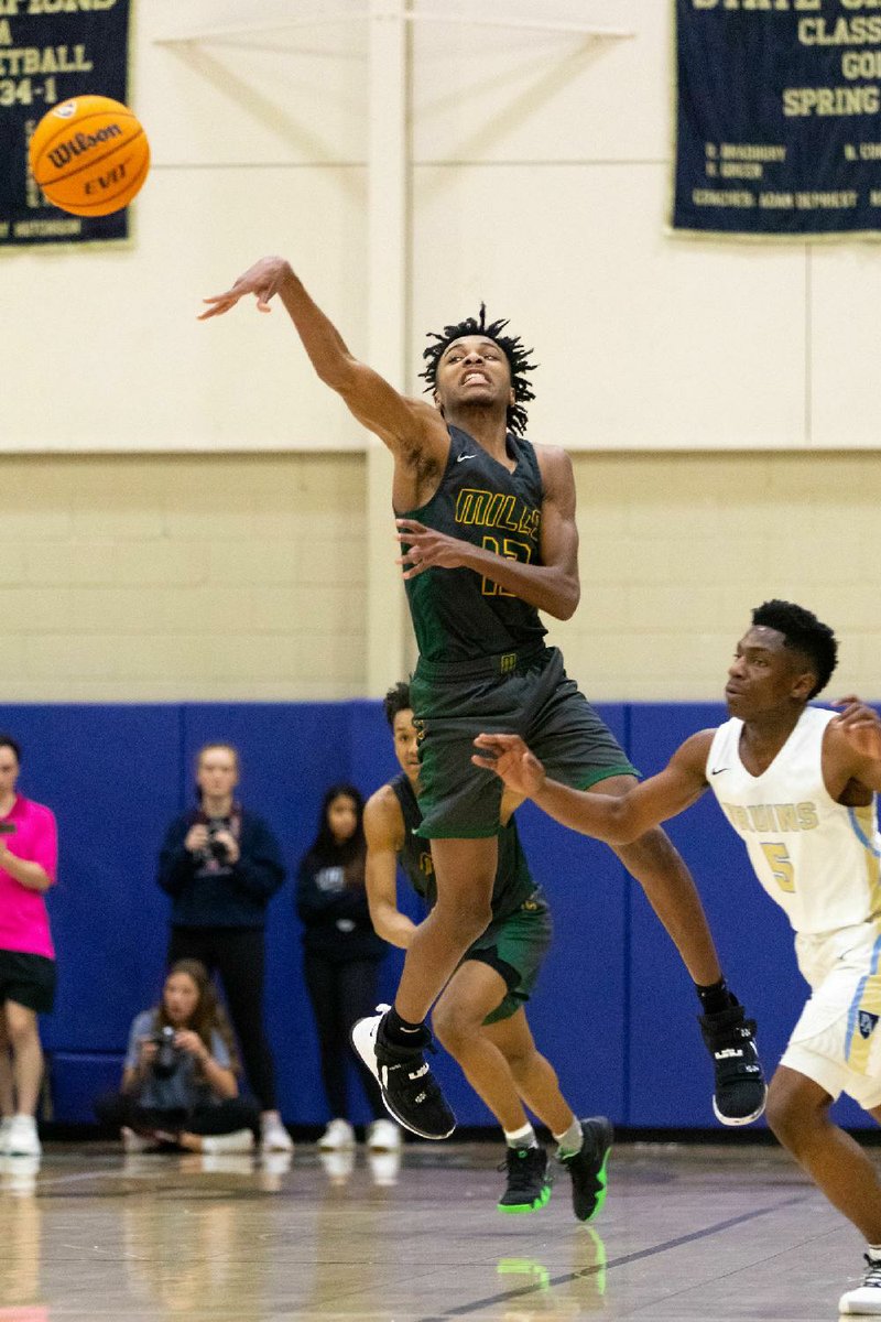 Mills point guard Dakalin Baker (left) launches a pass down court  during the second quarter of the Comets’ 65-61 victory over Pulaski Academy on Tuesday at Alex Hugg Gymnasium.
(Arkansas Democrat-Gazette/Justin Cunningham)