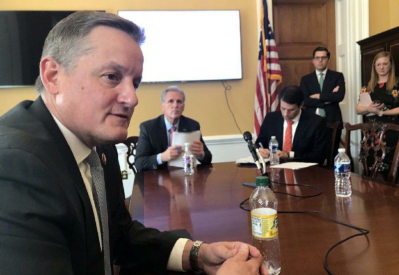 U.S. Rep. Bruce Westerman (left) discusses his so-called Trillion Trees Act legislation at a news conference Wednesday at the U.S. Capitol in Washington. Those watching included House Republican Leader Kevin McCarthy of California (holding papers).
(Arkansas Democrat-Gazette/Frank E. Lockwood)