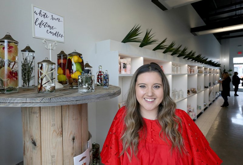 Eden Garrett, with Eden's Botanicals, stands at the entrance of her new brick and mortar store at Uptown Apartments and Retail in Fayetteville. Garrett started her business with a mobile flower truck. Check out nwadg.com/photos for a photo gallery. (NWA Democrat-Gazette/David Gottschalk)