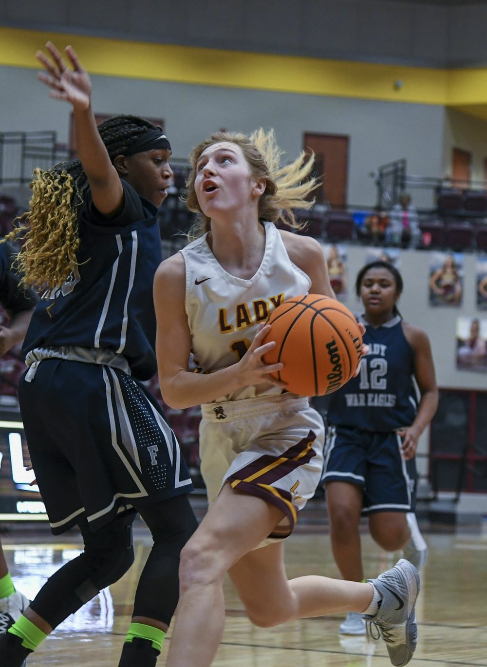 Lake Hamilton junior Aspen Thornton drives past J.A. Fair junior Nikiah Samuels in Wednesday's game at Wolf Arena. - Photo by Grace Brown of The Sentinel-Record