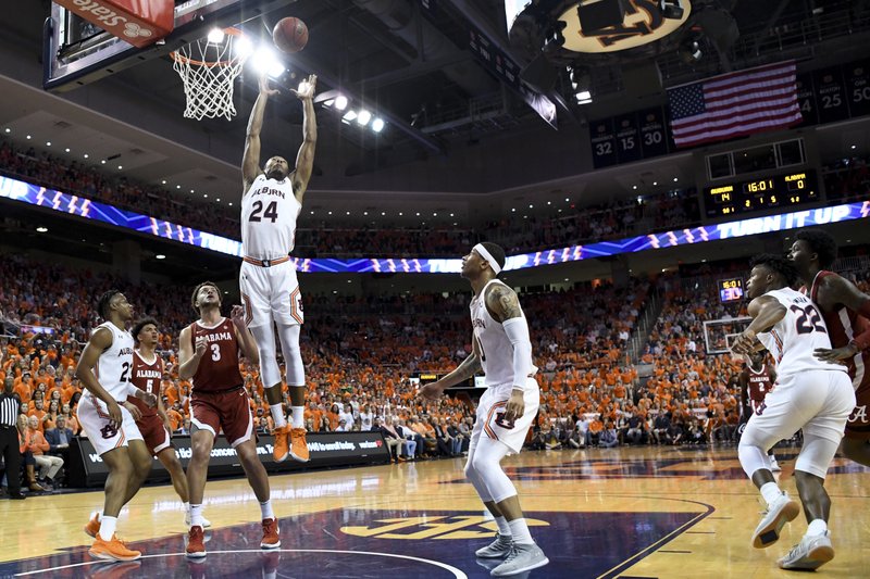 Auburn forward Anfernee McLemore (24) grabs a rebound over Alabama during the first half of an NCAA college basketball game, Wednesday, Feb. 12, 2020, in Auburn, Ala. (AP Photo/Julie Bennett)