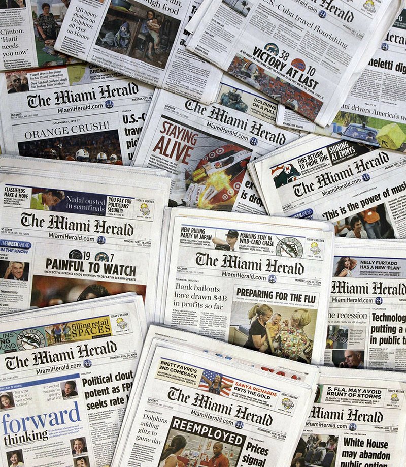 This Oct. 14, 2009 file photo, shows copies of the McClatchy Co. owned Miami Herald newspaper in Miami. McClatchy Co., the publisher of the Miami Herald, The Kansas City Star and dozens of other newspapers across the country is filing for bankruptcy protection. McClatchy Co. said Thursday, Feb. 13, 2020, that it will continue to run normally as it pursues approval of its restructuring plan under Chapter 11. (AP Photo/Wilfredo Lee, File)