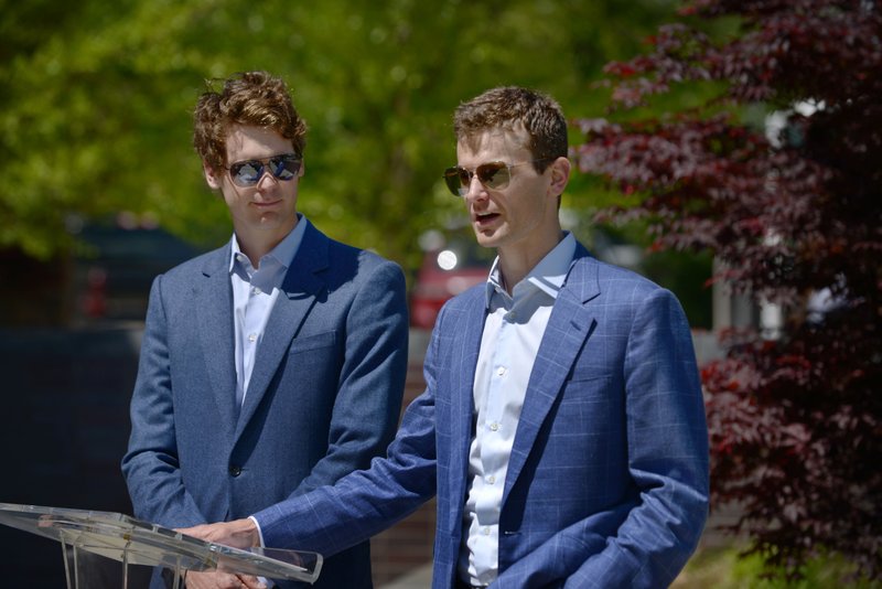 Tom Walton (left) and brother Steuart Walton address guests on Thursday April 21, 2016 during a luncheon for recipients of the Walton Family Foundation's Innovation Competition grants at 21c Museum Hotel in Bentonville. 